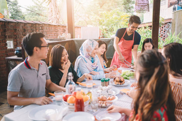 istock a group of multi ethic friends dinner party gathering at villa during weekend for feast 1152465383