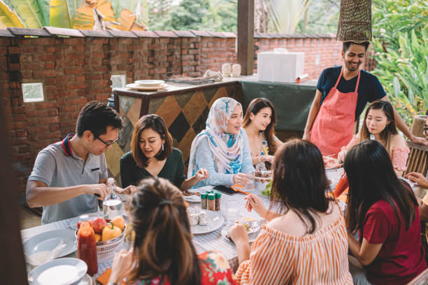 istock a group of multi ethic friends dinner party gathering at villa during weekend for feast 1152465388