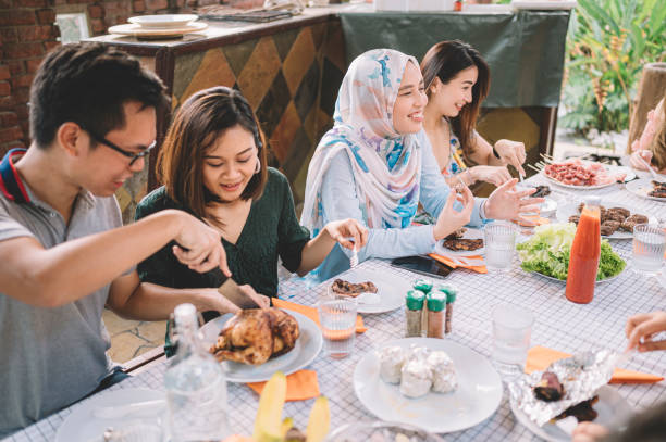istock a group of multi ethic friends dinner party gathering at villa during weekend for feast 1152465390