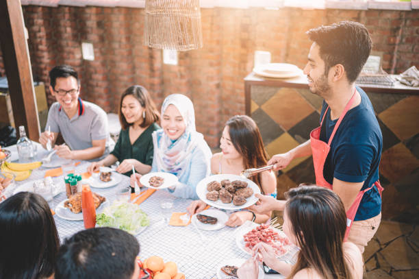 istock a group of multi ethic friends dinner party gathering at villa during weekend for feast 1152465391