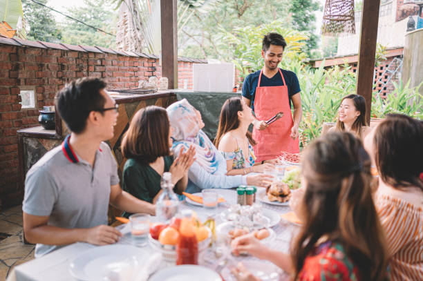 istock a group of multi ethic friends dinner party gathering at villa during weekend for feast 1152465392