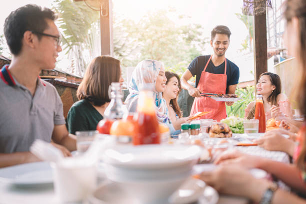istock a group of multi ethic friends dinner party gathering at villa during weekend for feast 1152465394