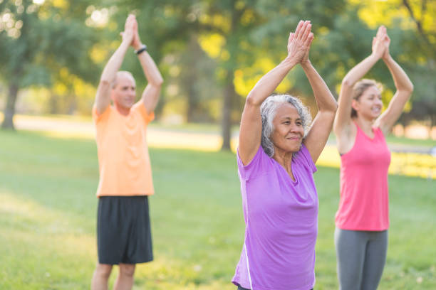istock Co-ed fitness group exercising outside 1152465408