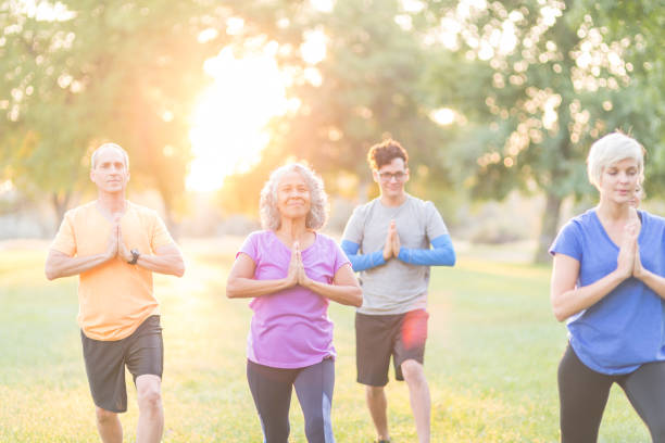 istock Mixed-age group doing a fitness class together outdoors 1152465425
