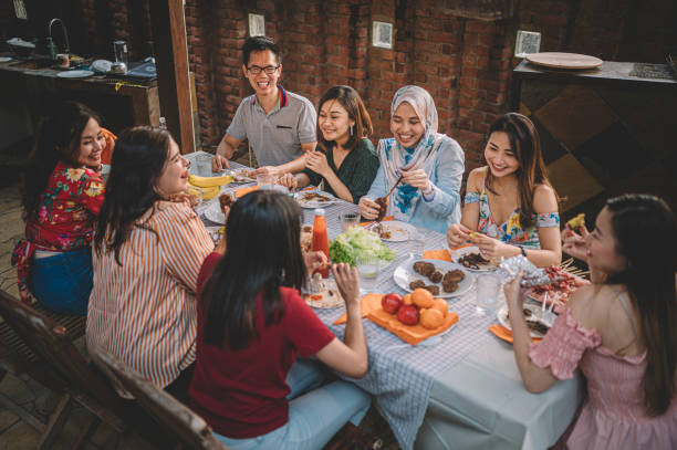 istock a group of multi ethic friends having dinner gathering outdoor during weekend 1152465452