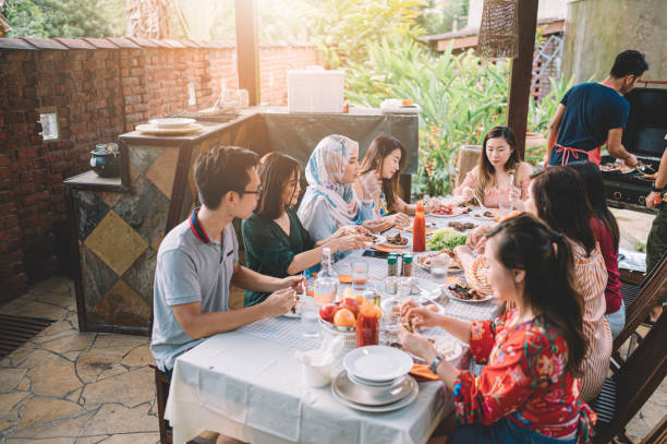 istock a group of multi ethic friends having dinner gathering outdoor during weekend 1152465473