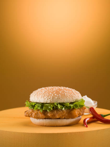 istock Chicken burger on golden background. 1152465817