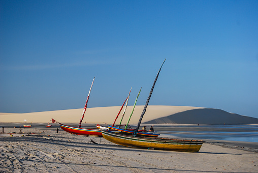 June 13 2012 Jericoacoara Ceara Brazil Fishing boats sit on the beach early morning at low tide by the sand dunes.