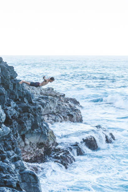 istock A male dives off a cliff into the Hawaii ocean 1152466482