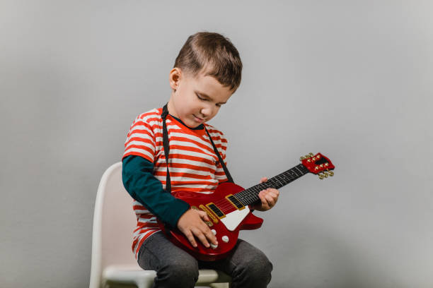 istock Child playing electric guitar. 1152466524