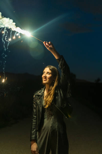 istock Woman holding a sparkler at night 1152467729