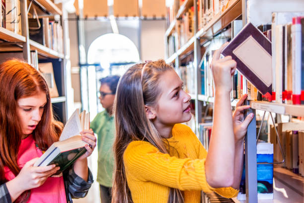 istock school friends doing some research together in the library 1152468023