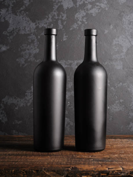 istock Red wine bottle on a wooden background 1152469335