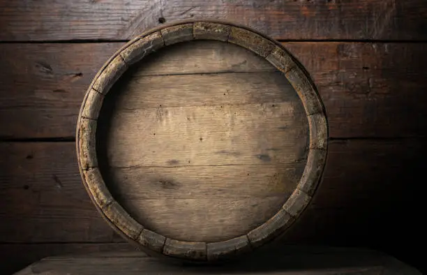 Photo of background of barrel and worn old table of wood