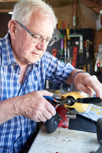 istock Senior Man Working On Model Radio Controlled Aeroplane In Shed At Home 1152470708