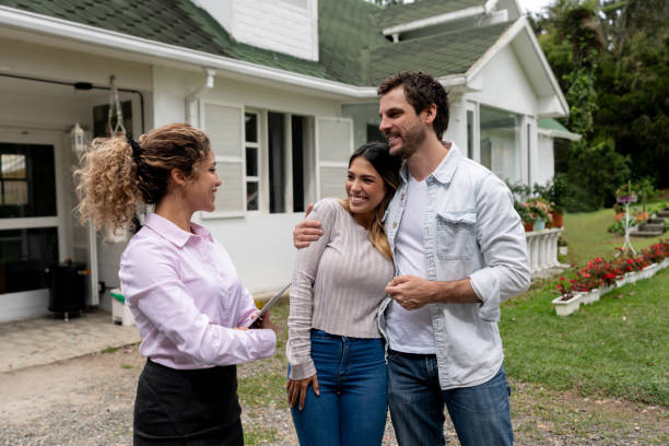 istock Real estate agent showing a couple a beautiful house 1152470845
