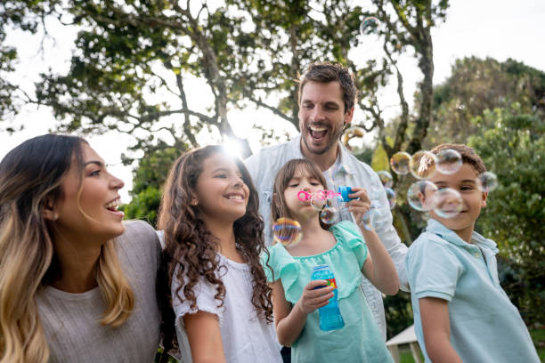 istock Happy family playing at the park making bubbles 1152470880