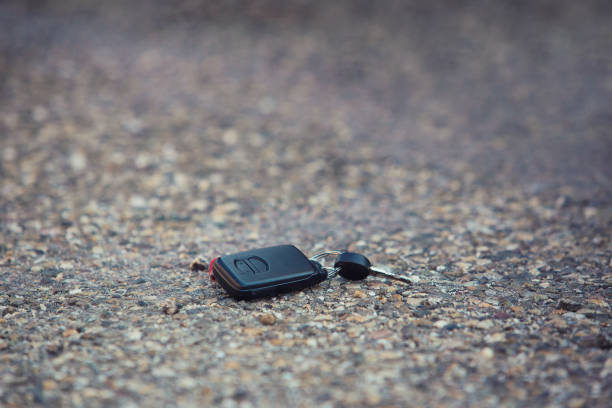istock Car key fall on the asphalt road. Driver lost his vehicle keys. 1152471206