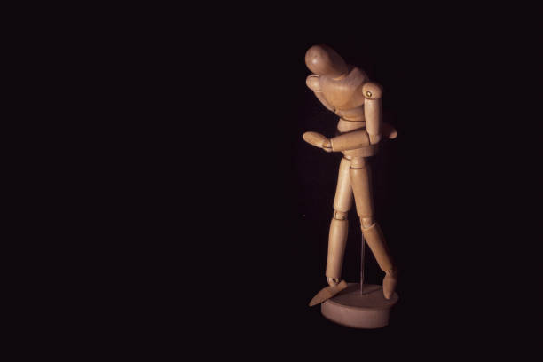 istock Wooden Human Manikin posing on a black background. 1152471941