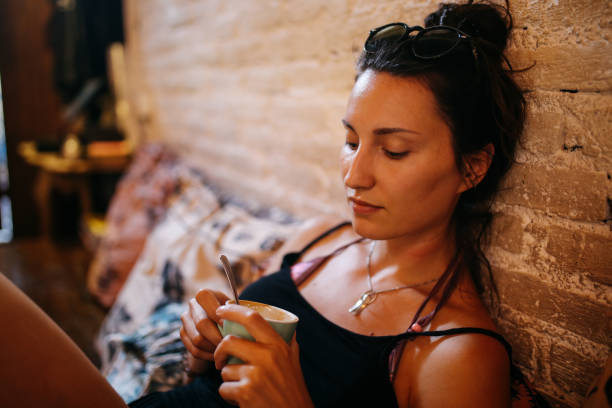 istock laid back young woman enjoying coffee a Bali cafe 1152472419