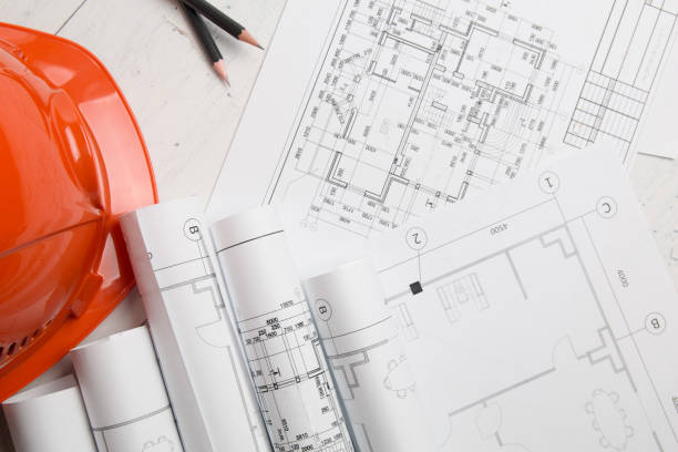 istock Architectural plan. Engineering house drawings, helmet, pencilsand blueprints. 1152475810