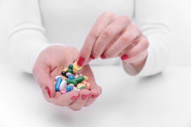 istock Beautiful female hand holds pill gesture. 1152475946