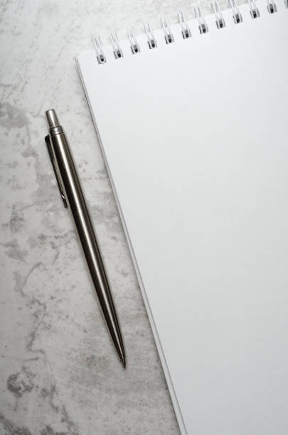 istock Notepad with metal gray pen on a stone background. Concept elegant business style. Copy space, top view, flat lay. 1152477178