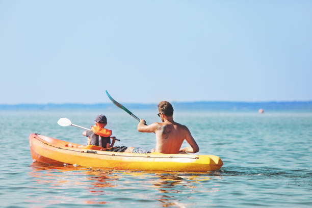 istock Father And Son Rowing Kayak On Lake 1152477271