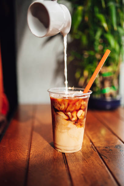 istock Pouring cream in cold coffee 1152485688