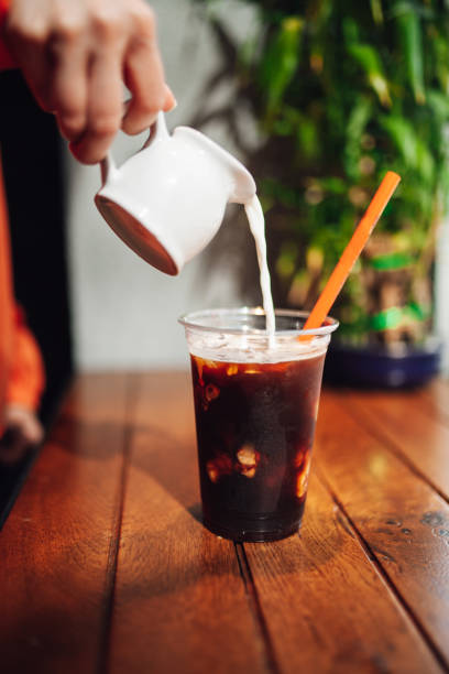 istock Pouring cream in cold coffee 1152485737