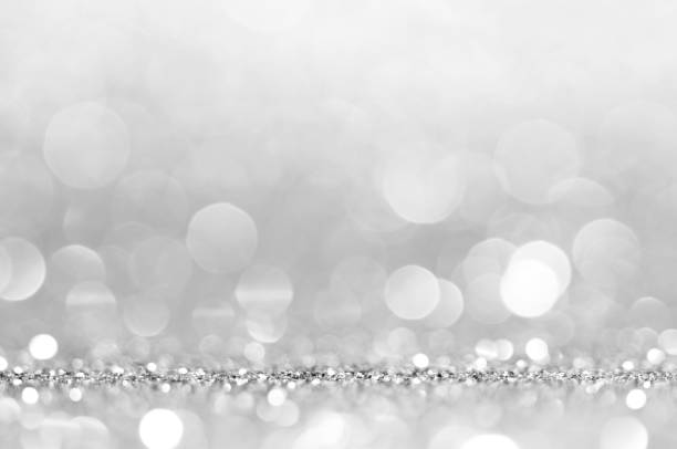 istock Silver white abstract light grey background, shining lights, sparkling glittering Christmas lights. Blurred abstract holiday background. 1152488151