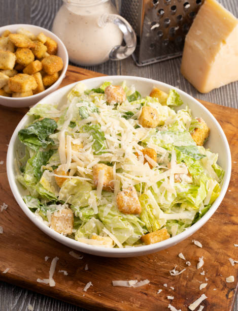 istock Fresh Caesar Salad on a Wooden Table with Grated Parmesan 1152496645