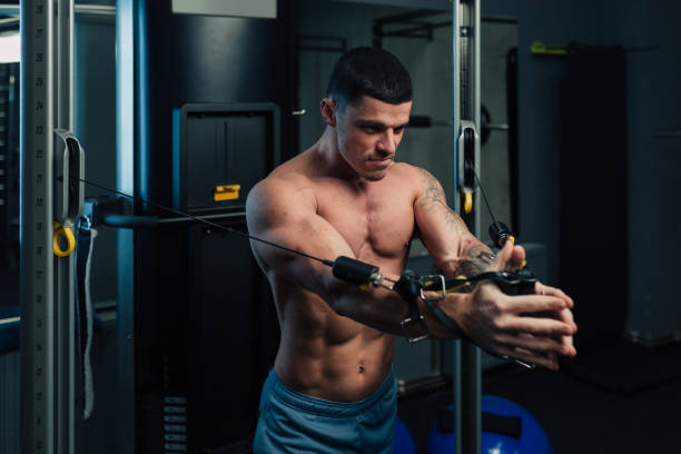 istock Young strong man in gym doing chest cable workout 1152496987