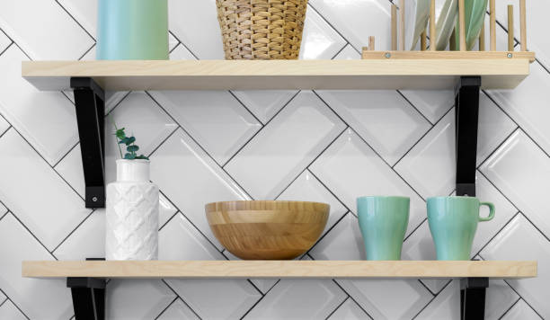 istock Kitchenware green cups and white vase on wooden shelves 1152497097