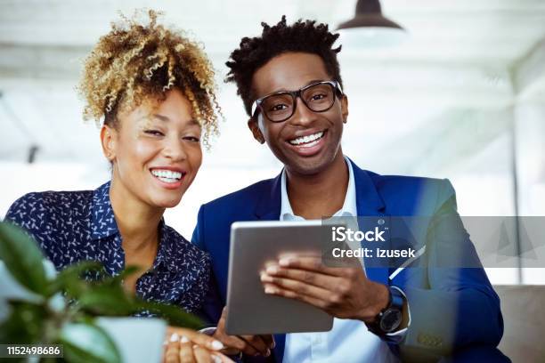 Portrait Of Cheerful Financial Advisors In Office Stock Photo - Download Image Now - Looking At Camera, African-American Ethnicity, Colleague