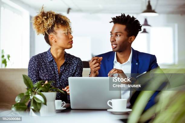 Businessman Discussing Investment Plans With Woman Stock Photo - Download Image Now - 30-34 Years, Adult, Adults Only