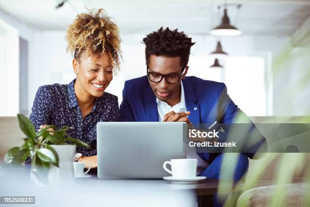 Confident White Collar Workers Looking At Laptop Stock Photo - Download Image Now - Laptop, Looking, 30-34 Years