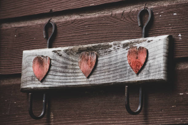 A photograph of a rustic wooden heart hanging farmhouse decor