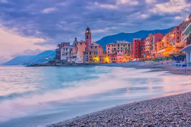 Tranquil scene at the beach of the famous fishing village of Camogli at dusk. Long exposure.