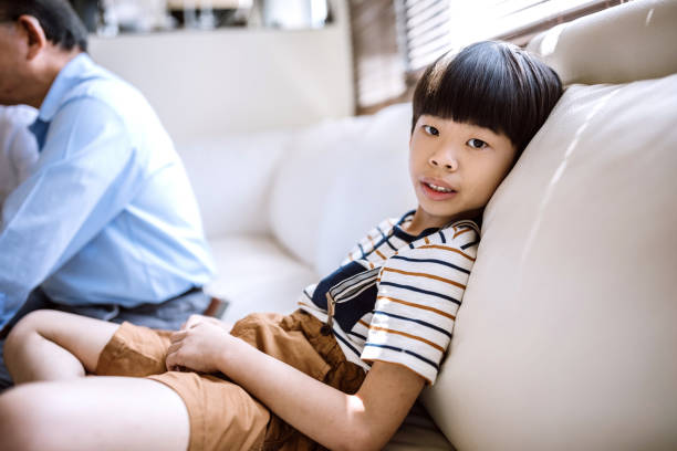 istock Carefree Boy Relaxing On Sofa 1152515652