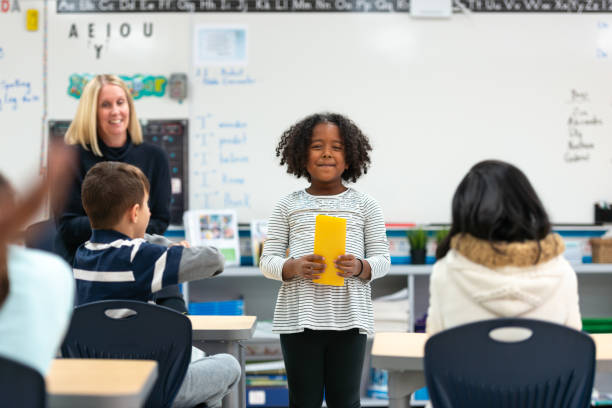 istock Young African Girl Presenting to Her Class 1152517609