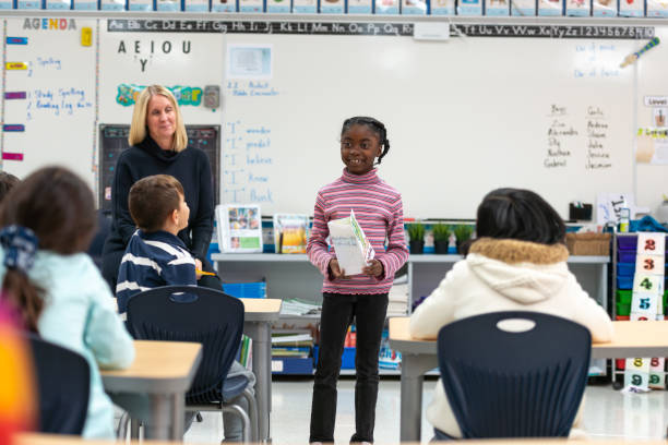 istock Young African Girl Presenting to Her Class 1152517610