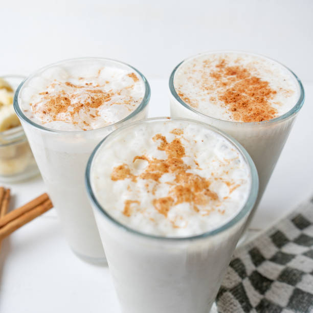 istock Banana smothie or milkshake with cinnamon on white  background 1152518350