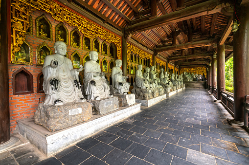 Ninh Binh, Vietnam - April 5th, 2019: Buddha statues along the corridor lead to Bai Dinh pagoda, one of the largest in the south east Asia in Ninh Binh, Vietnam