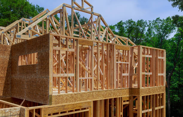 istock Looking up new construction beams under a clear blue sky with sunlight 1152529183