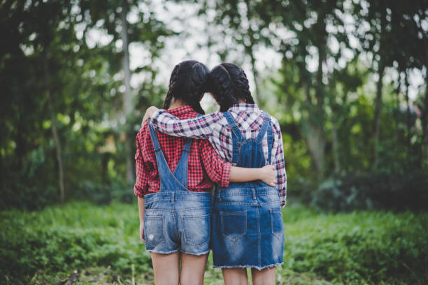 istock Two girls hand holding together 1152532510