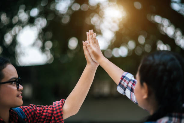 istock Two girls college student giving high five celebrating 1152532640