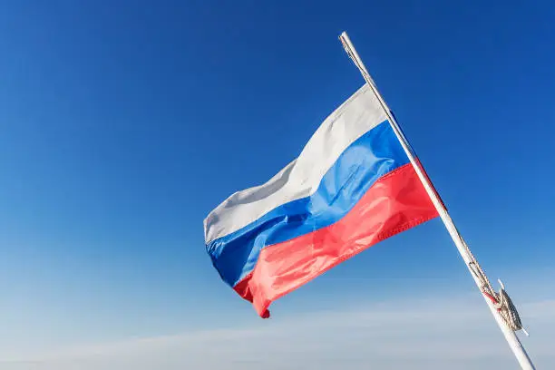 Russian flag flying in the wind against the sky