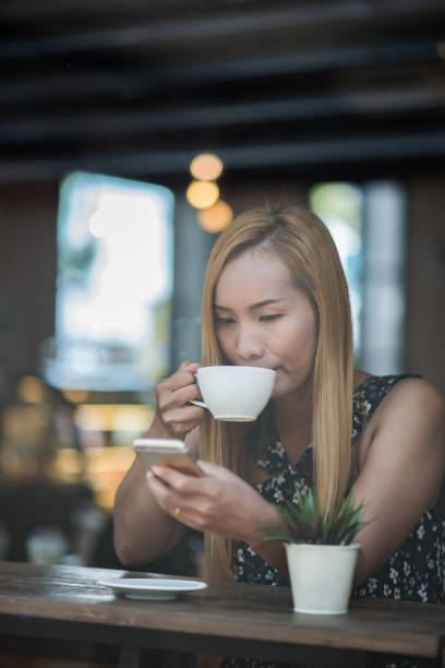 istock Beautiful woman in a cafe drinking coffee 1152536671