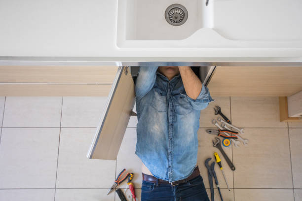 istock Plumber working with broken and leaking kitchen plumbing 1152537118